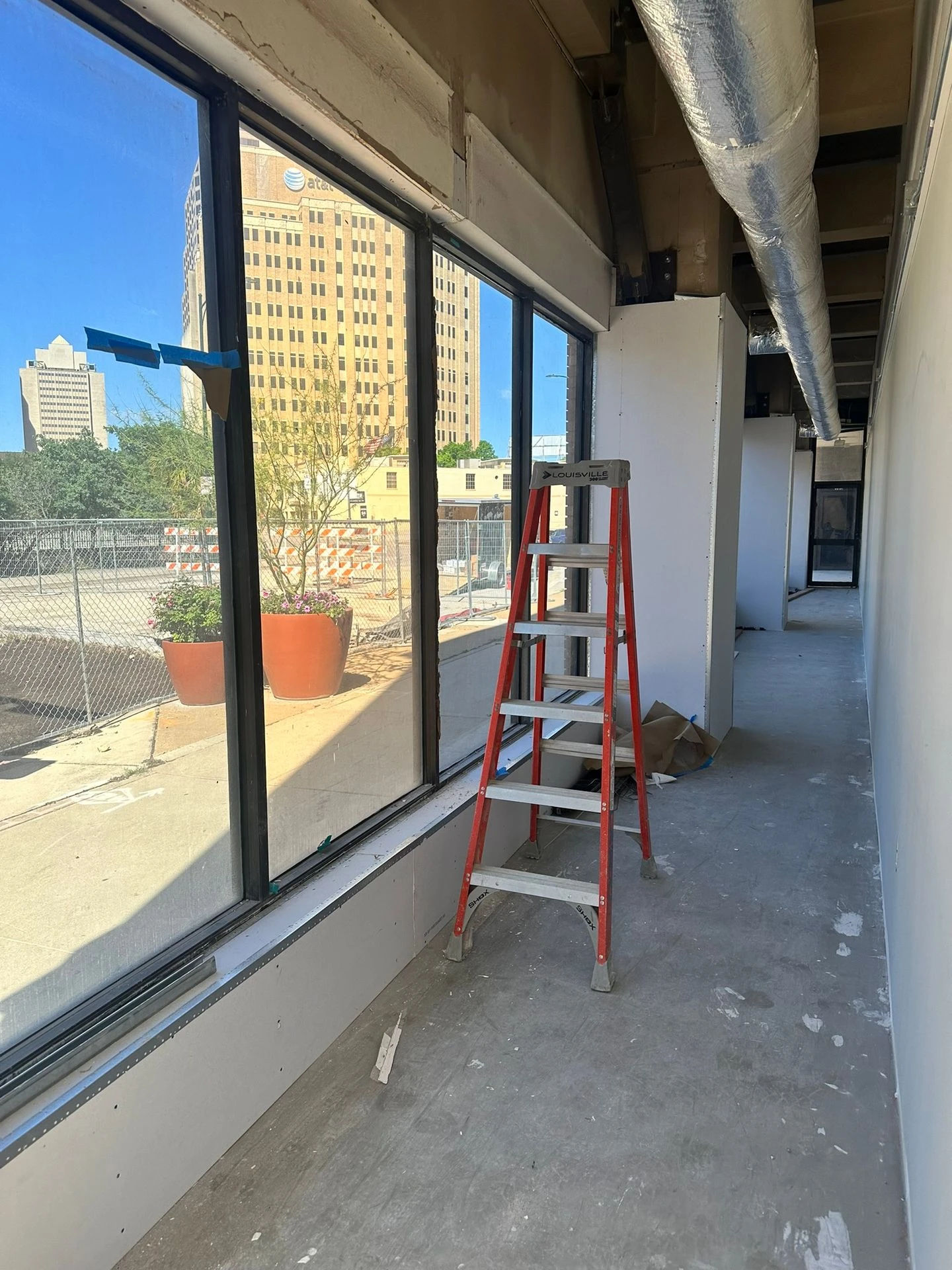 Safety and security window film on downtown office glass during a buildout